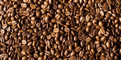 Background of roasted coffee beans full frame. A coffee-themed banner. Stock Photos