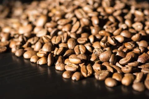 Background of roasted coffee beans lit by the sun Stock Photos