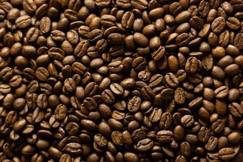 Background of roasted coffee beans. Top down view of full bean coffee Stock Photos