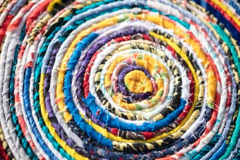 Background roll of twisted fabric close-up. Many rags of different colors Фото