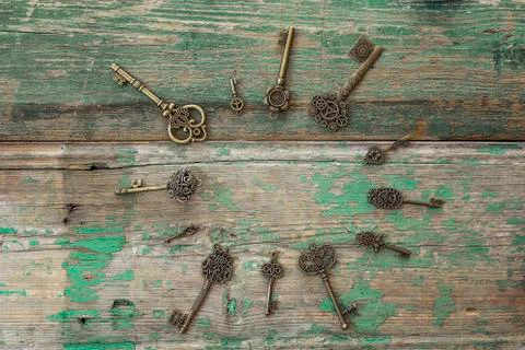 Background with round frame of antique keys on old painted wooden boards. Cop Stock Photos