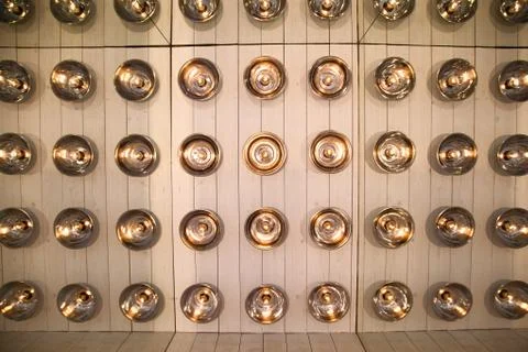 Background of round lamps on the wall Stock Photos