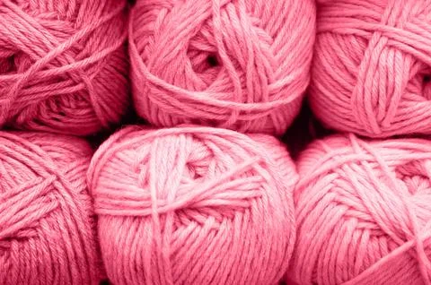 Background of rows skeins of fluffy wool yarn for knitting soft red pink purp Stock Photos