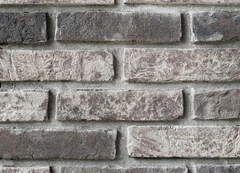 Background of rustic sandblasted bricks wall. Stock Photos