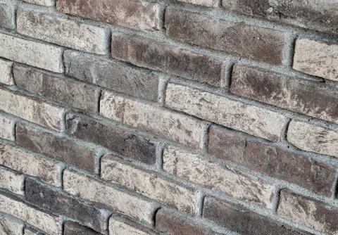Background of rustic sandblasted bricks wall. Stock Photos