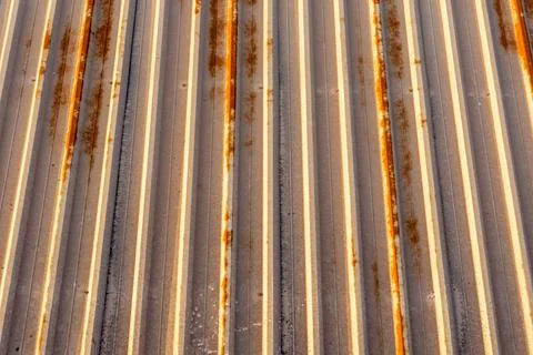 Background of rusty metal material mounted on a ceiling of a factory in panel Stock Photos