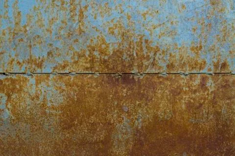 Background of a rusty metal sheet divided by a strip into two halves. Tests of Stock Photos
