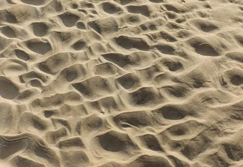 Background of sand where waves have previously crated a ripple Foto stock