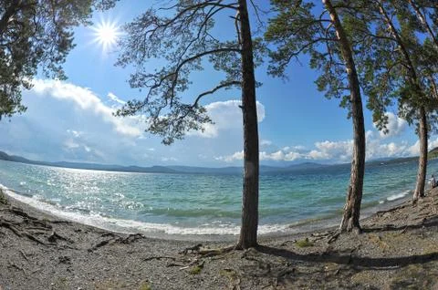 The background of sandy beaches, waves and storm clouds over the mountains Foto stock