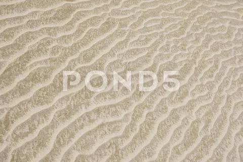 Background of sandy dune of pale beige color Stock Photos