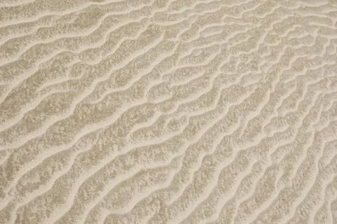 Background of sandy dune of pale beige color Stock Photos