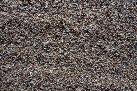 The background of the sandy surface is close-up. The texture of the sand on the Foto stock