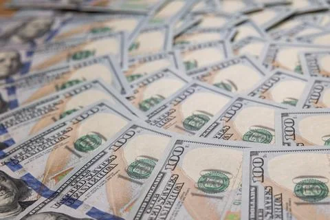 Background of Scattered One Hundred US Dollar Bills Representing Wealth and.. Stock Photos