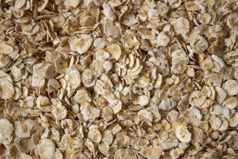 Background of scattered raw oatmeal. Texture of spilled oatmeal Stock Photos