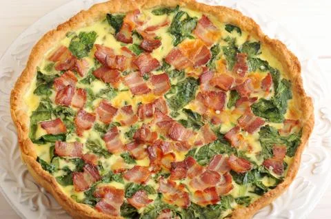 Background from scrambled eggs with spinach and bacon Stock Photos