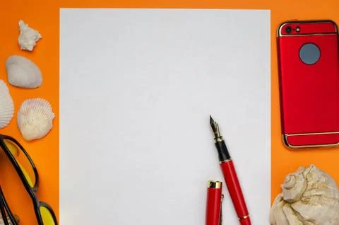 Background with seashells a white sheet of paper with a red pen and a red pho Stock Photos