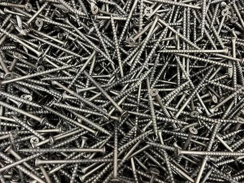 Background of self-tapping screws in close-up. Texture of self-tapping screws Stock Photos