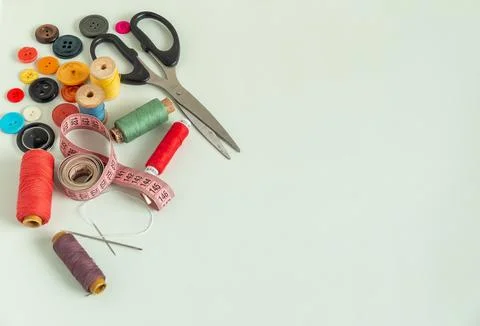 Background for sewing. Needlework supplies on a light background. Spools of t Stock Photos