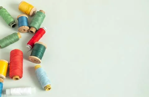 Background for sewing. Needlework supplies on a light background. Spools of t Stock Photos