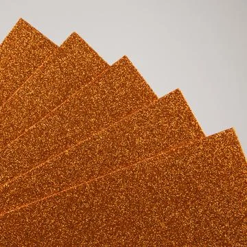A background of shiny orange foam sheets. Stock Photos