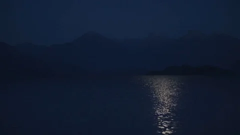 Background shot moon reflection on a lake in front of mountains in Patagonia 스톡 동영상 70449869
