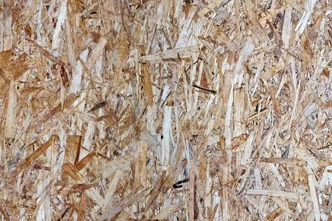 Background showing texture of oriented strand board panel OSB. Compressed woo Stock Photos