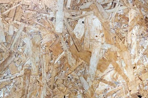 Background showing texture of oriented strand board panel OSB. Compressed w.. Stock Photos