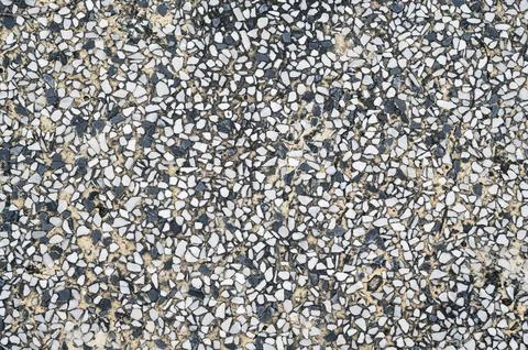 Background with sidewalk texture with pebbles. Natural cement road surface Stock Photos