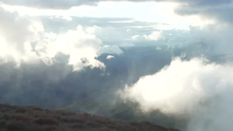 Background silhouettes of mountain ranges the sun breaking through the clouds. Stock Footage 214325795