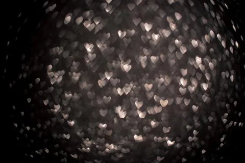 Background with silver bokeh in the shape of a heart. Stock Photos