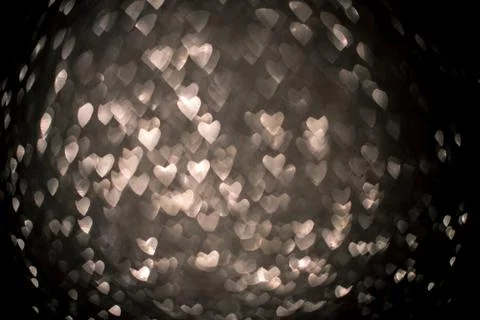 Background with silver bokeh in the shape of a heart. Stock Photos