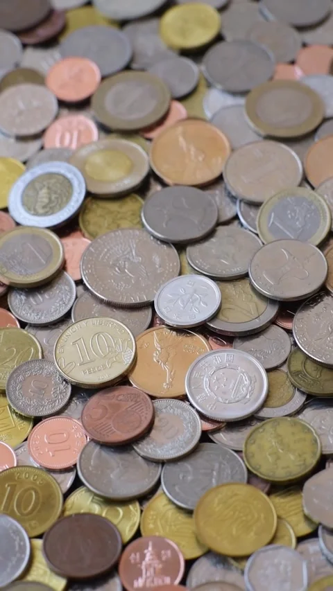 A background of silver, gold, and copper coins of various denominations. Metal c Stock Footage 333187612