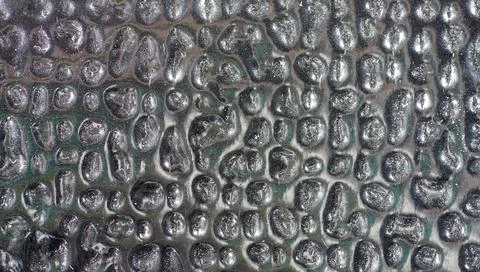 Background of silver metal surface with bumpy pattern Stock Photos