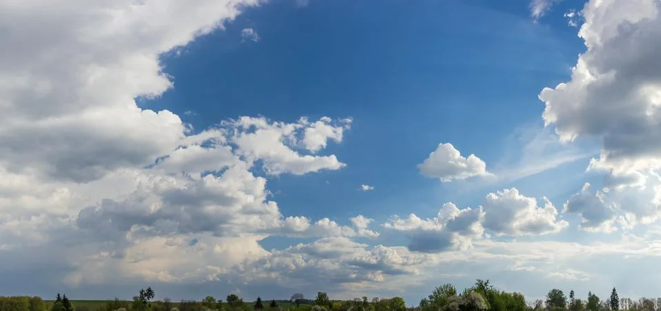 Background of the sky with cumulus clouds in springtime Stock Photos