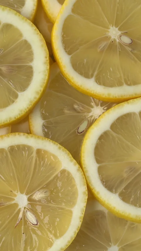 Background of sliced lemons.  Vertical video. Stock Footage 310433411