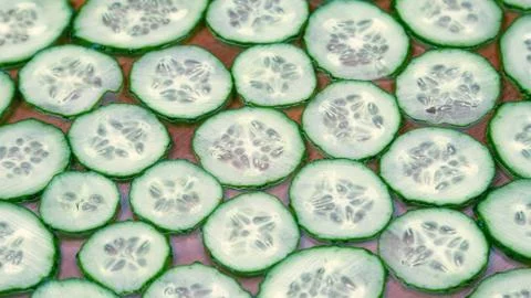 Background from sliced thin slices of cucumber Stock Photos