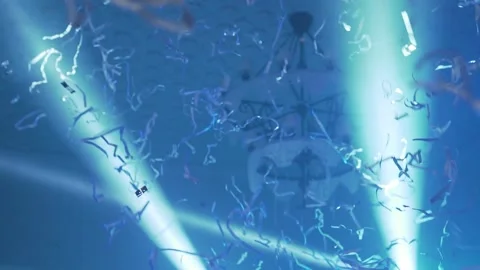 Background Slow-motion confetti on the party with scenic blue lights. Nobody Stock Footage 234453608