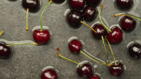 Background slow motion video of cherries falling into water with cherries. Video stock 278828981