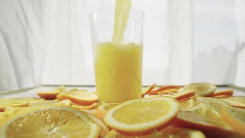 Background slow motion video pouring freshly squeezed orange juice into glass Stock Footage 241794826