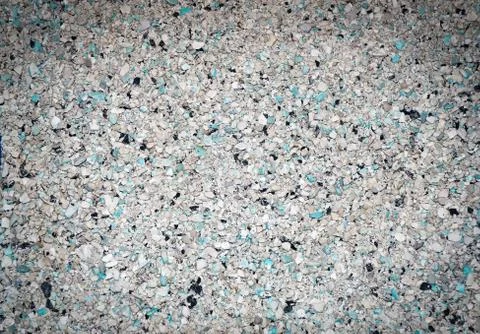 Background of small blue, gray, white and black small granules with vignettin Stock Photos