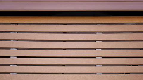 The background of a small plaster wall is attached to a horizontal steel barr Stock Photos