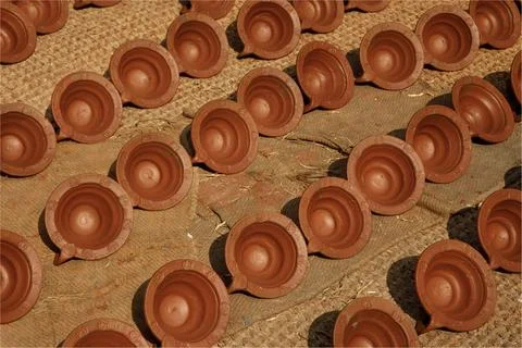 A background of small, round claypots drying in th sunshine on a carpet Stock Photos