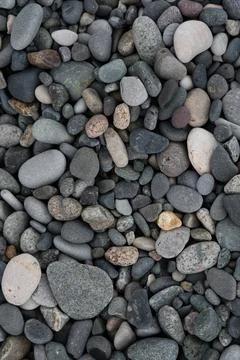Background of small round pebbles on the stone beach of Batumi Stock Photos