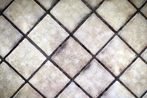 Background of Small Square Tan Floor Tiles in a Diagonal Pattern Stock Photos