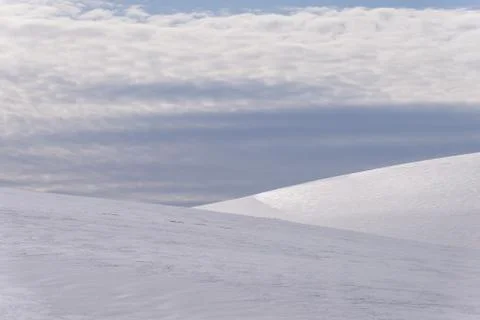 Background snow covered ground with clouds Stock Photos