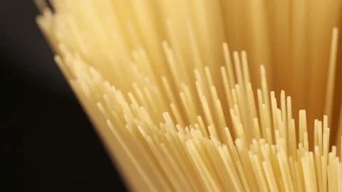 Background Of Spaghetti Pasta. Uncooked Italian Pasta Golden Rotating Backdrop Stock Footage 196155487