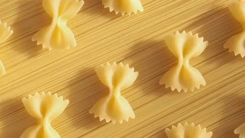 Background Of Spaghetti Pasta. Uncooked Italian Pasta Golden Rotating Backdrop Stock Footage 196155620