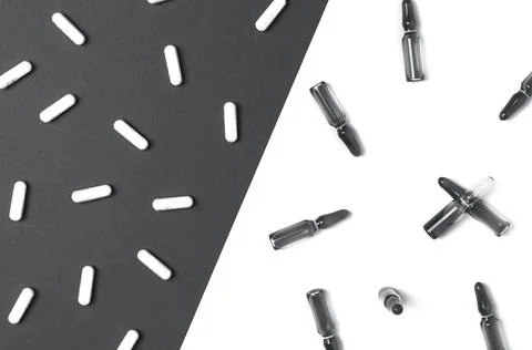 Background with spilled tablets and ampules toned in trendy grey color. Cosme Stock Photos