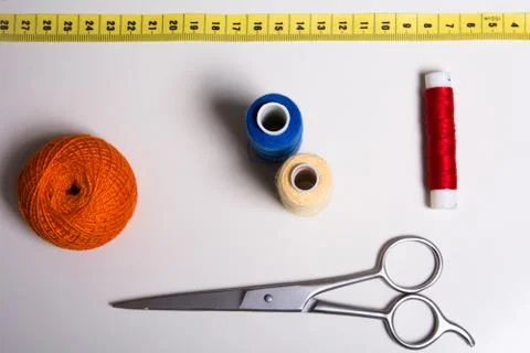 Background of a spool of multi-colored thread and scissors Stock Photos
