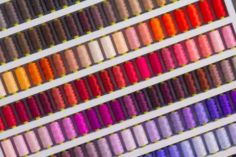 Background spool of sewing threads colorful sort in diagonal Stock Photos